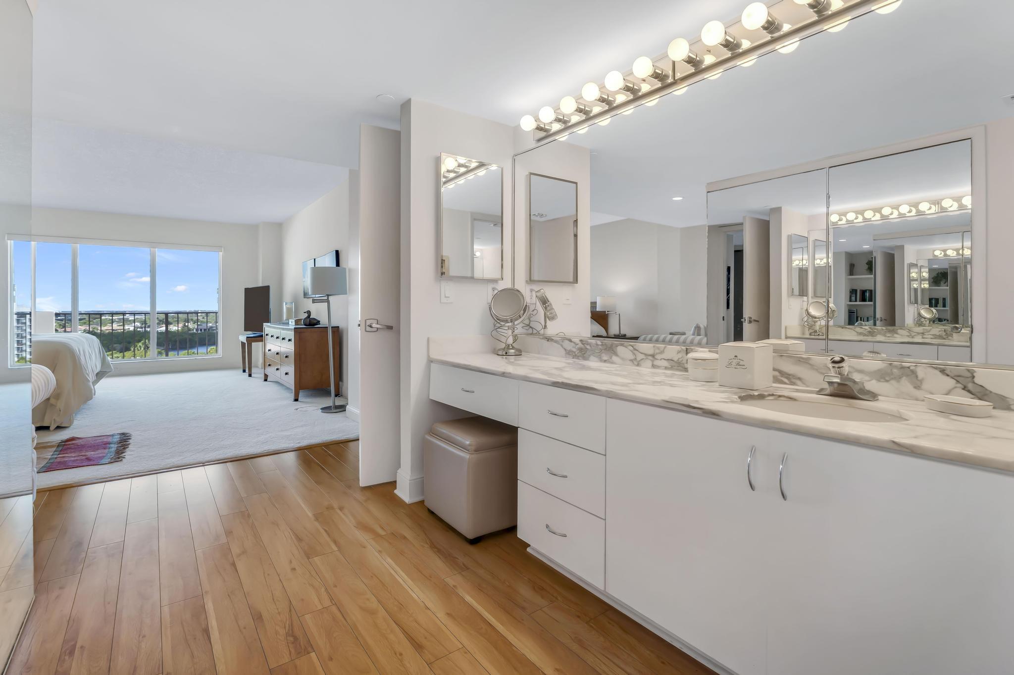 4301 North Ocean Boulevard, Unit 1002 Boca Raton, FL 33431 - Photo 25 of 71 a spacious bathroom with a granite countertop double vanity sink and a mirror