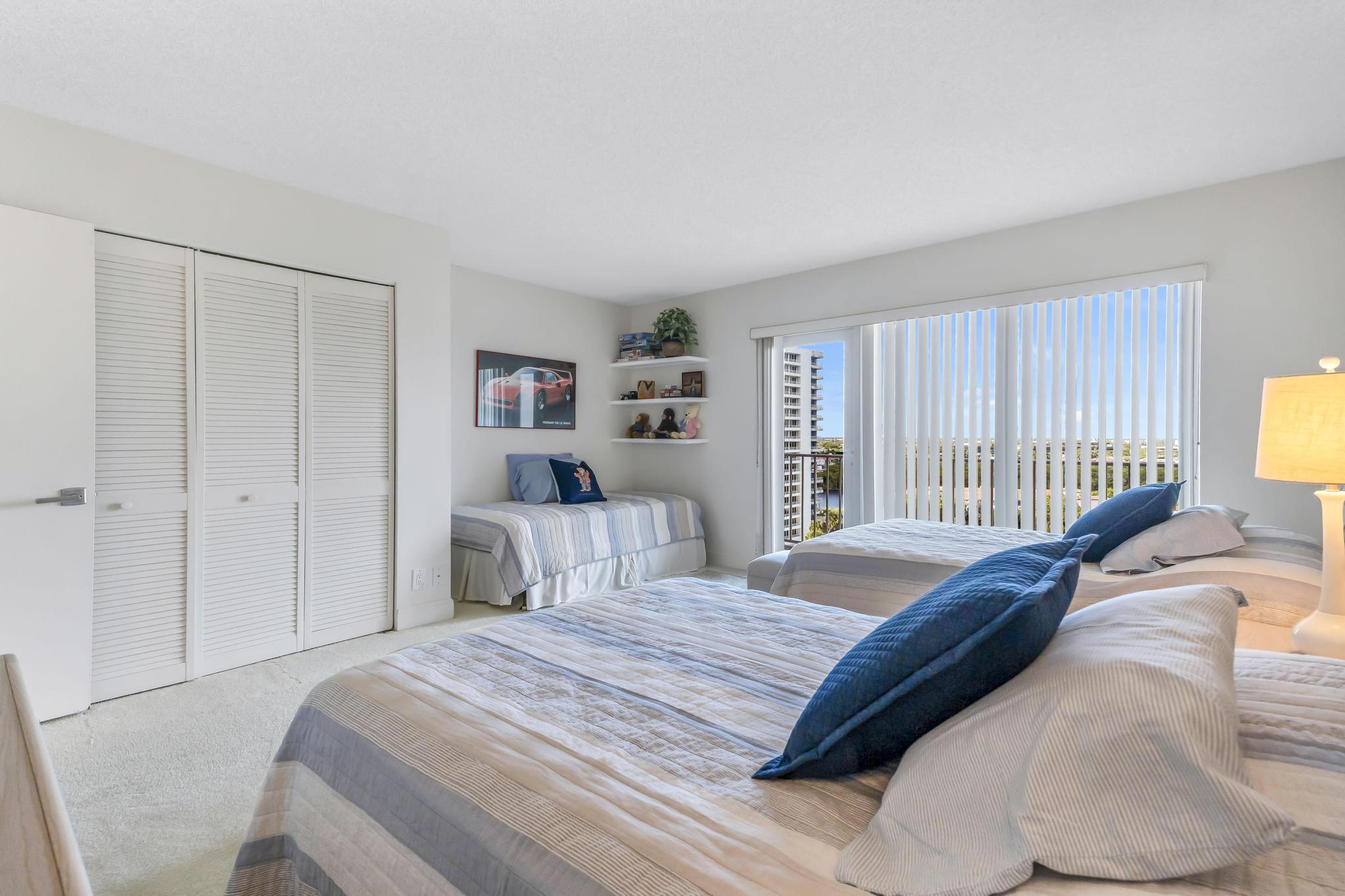 4301 North Ocean Boulevard, Unit 1002 Boca Raton, FL 33431 - Photo 29 of 71 a bedroom with a bed and a window