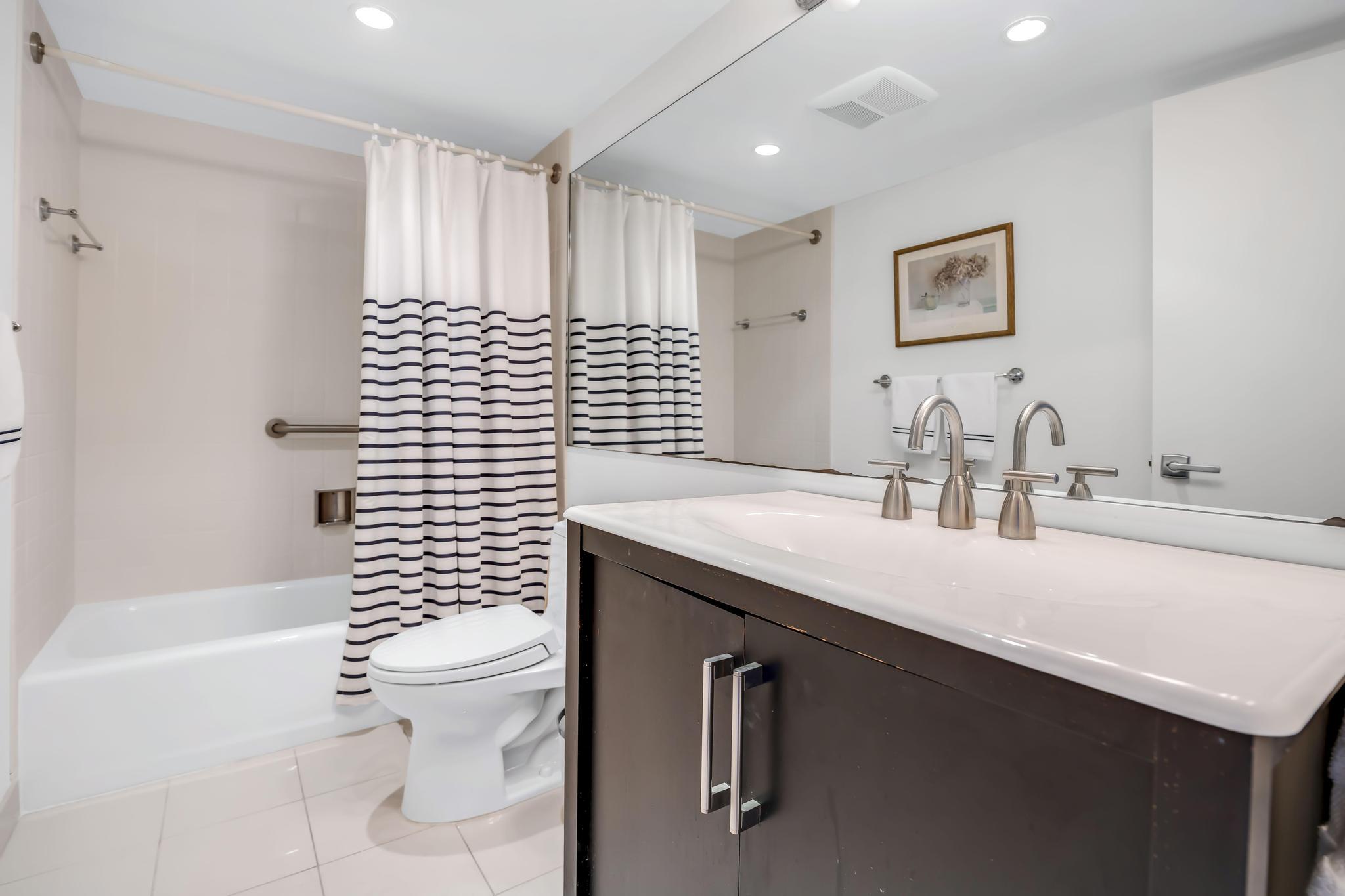 4301 North Ocean Boulevard, Unit 1002 Boca Raton, FL 33431 - Photo 31 of 71 a bathroom with a sink a toilet and shower