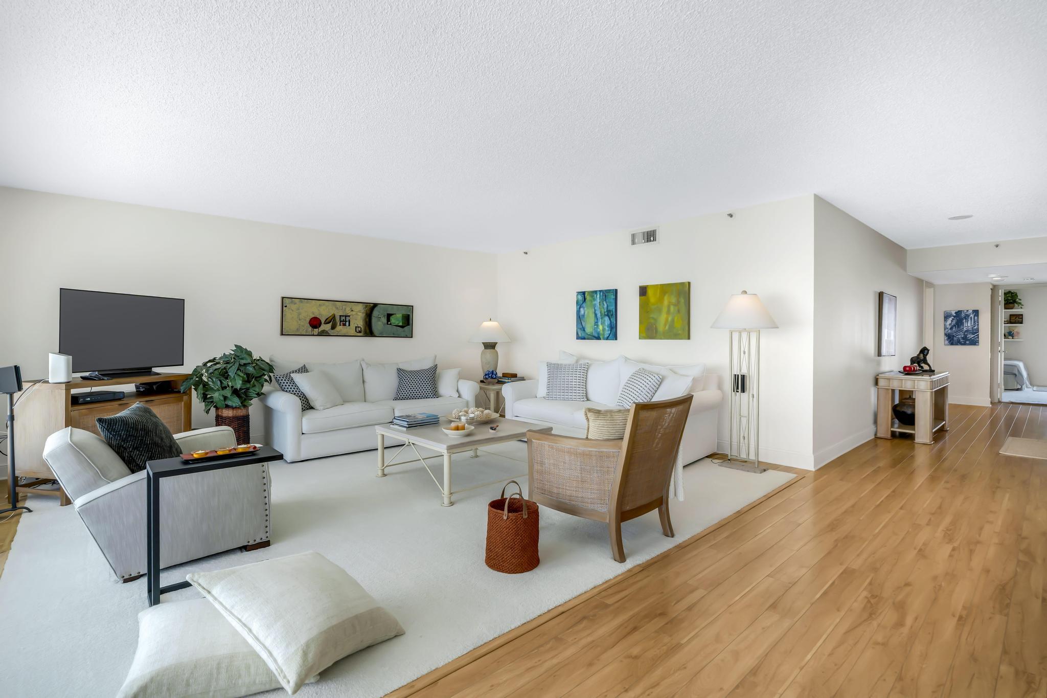 4301 North Ocean Boulevard, Unit 1002 Boca Raton, FL 33431 - Photo 5 of 71 a living room with furniture and a flat screen tv