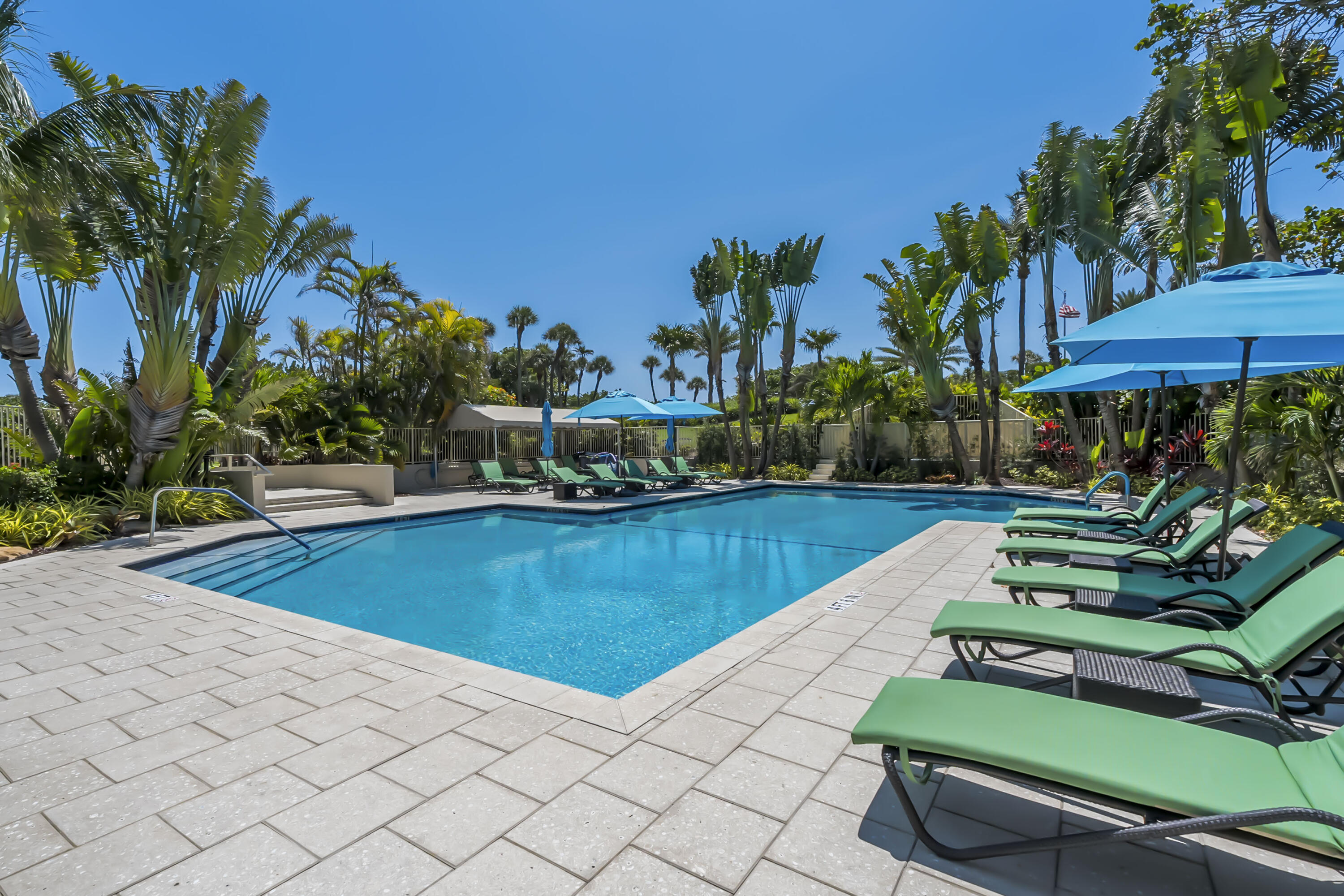 4301 North Ocean Boulevard, Unit 1002 Boca Raton, FL 33431 - Photo 65 of 71 a view of a swimming pool with chairs and plants