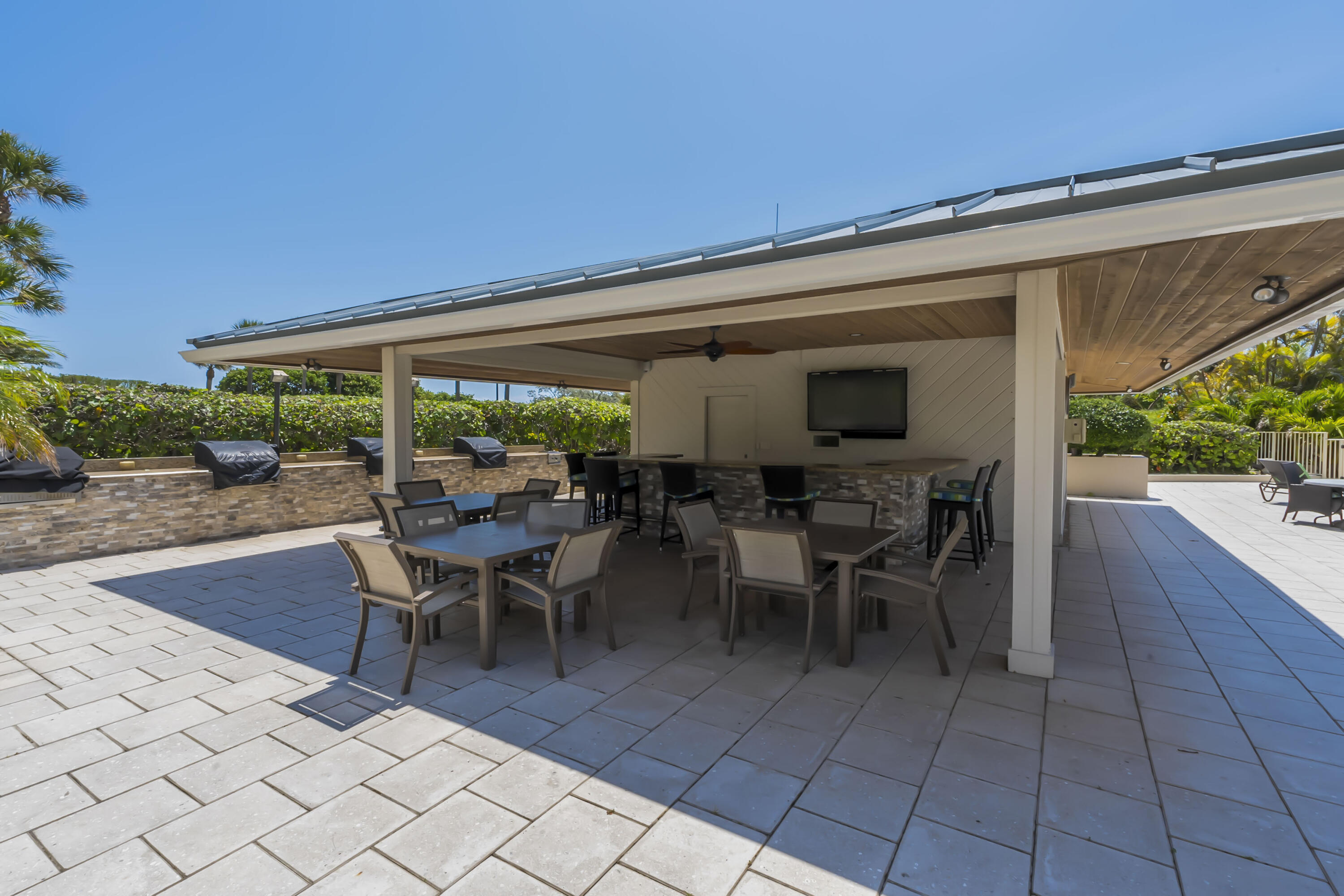 4301 North Ocean Boulevard, Unit 1002 Boca Raton, FL 33431 - Photo 68 of 71 a view of a patio with table and chairs potted plants with wooden floor