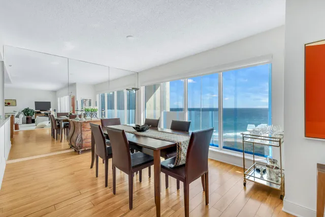 a kitchen with stainless steel appliances granite countertop a refrigerator a stove top oven a sink dishwasher and a refrigerator with wooden floor