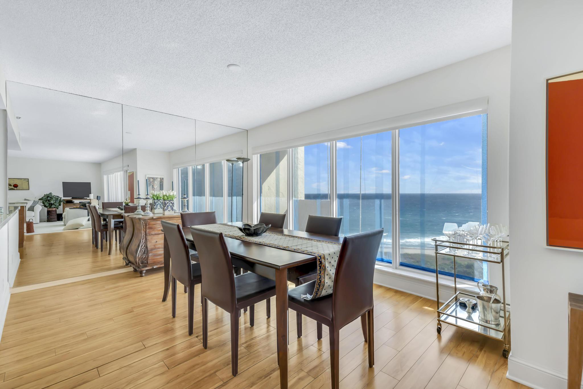 4301 North Ocean Boulevard, Unit 1002 Boca Raton, FL 33431 - Photo 8 of 71 a view of a dining room with furniture and wooden floor