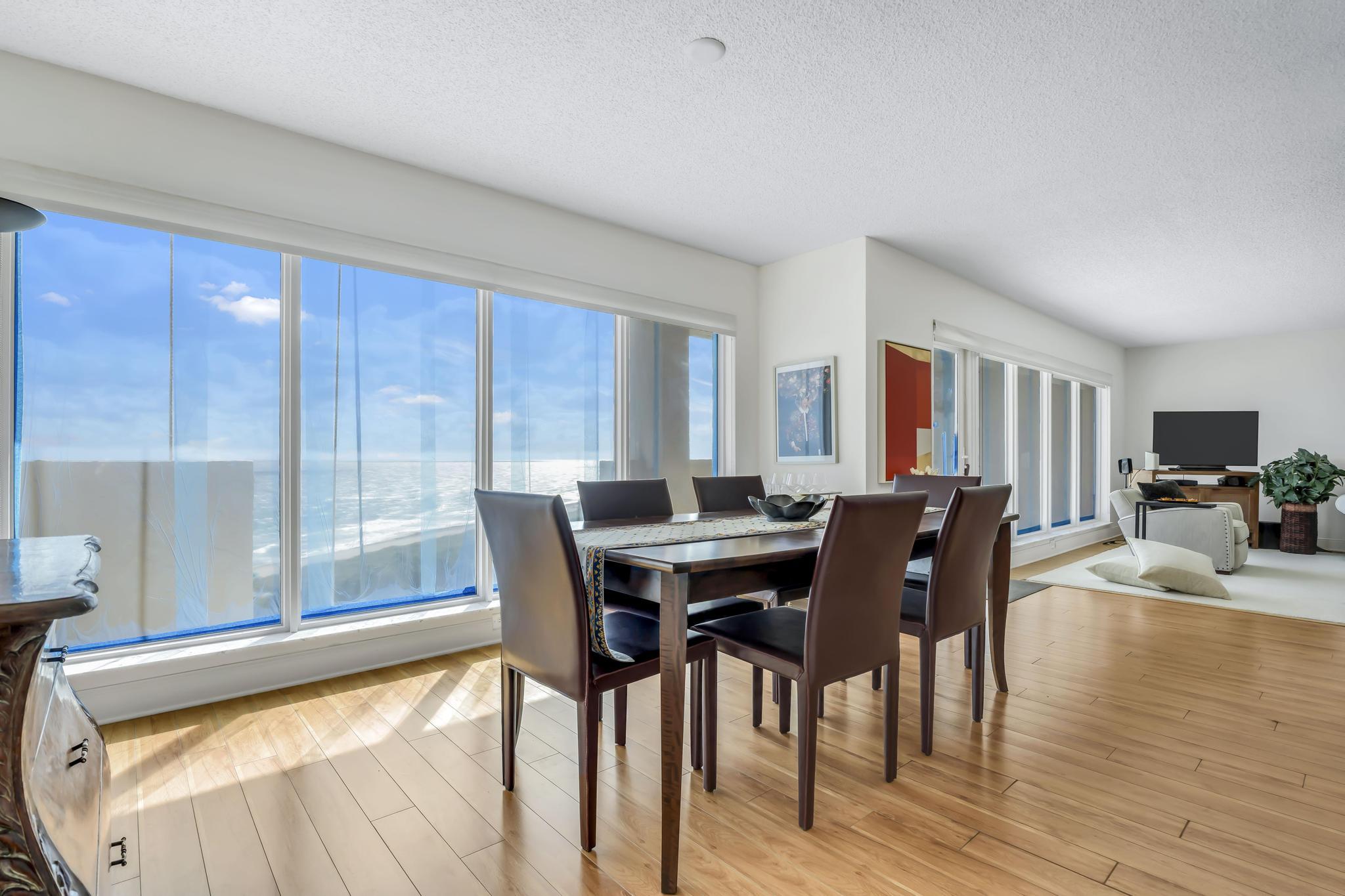 4301 North Ocean Boulevard, Unit 1002 Boca Raton, FL 33431 - Photo 9 of 71 a view of a dining room with furniture and wooden floor