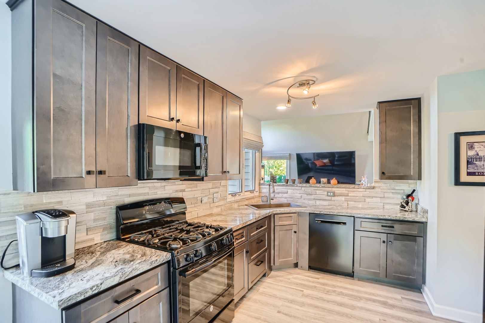 1083 Sumner Circle Gurnee, IL 60031 - Photo 11 of 27 a kitchen with stainless steel appliances granite countertop a sink stove microwave and cabinets