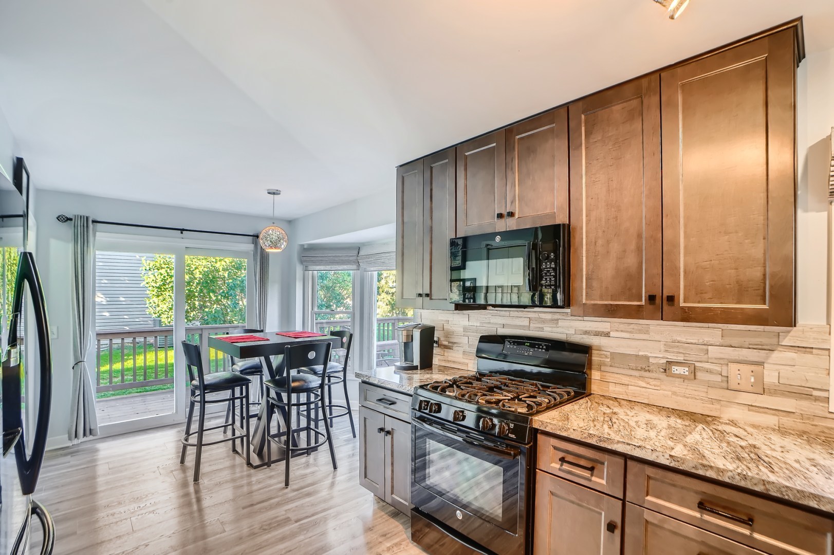 1083 Sumner Circle Gurnee, IL 60031 - Photo 13 of 27 a kitchen with a stove a sink and a wooden floors