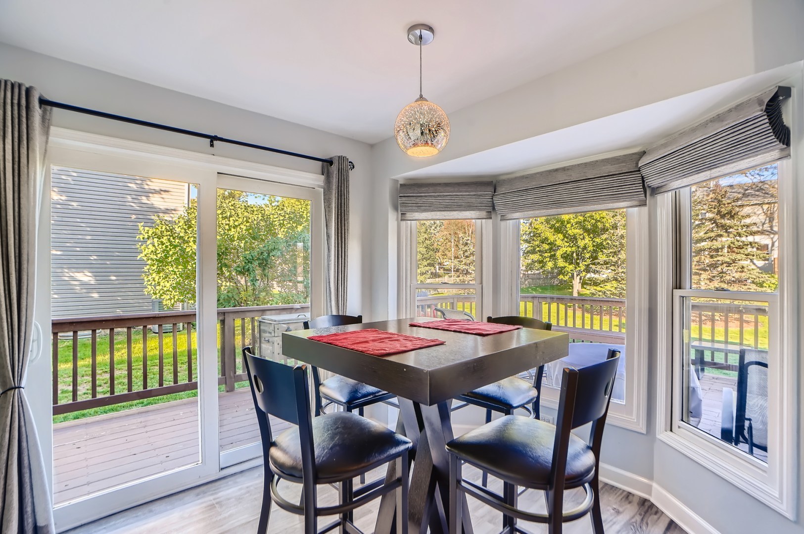 1083 Sumner Circle Gurnee, IL 60031 - Photo 14 of 27 a dining room with furniture a chandelier and wooden floor