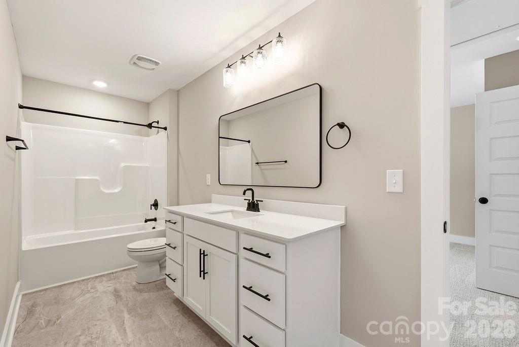 1020 Baylor Grove Road, Unit 20 Monroe, NC 28112 - Photo 40 of 45 a bathroom with a double vanity sink toilet mirror and bathtub