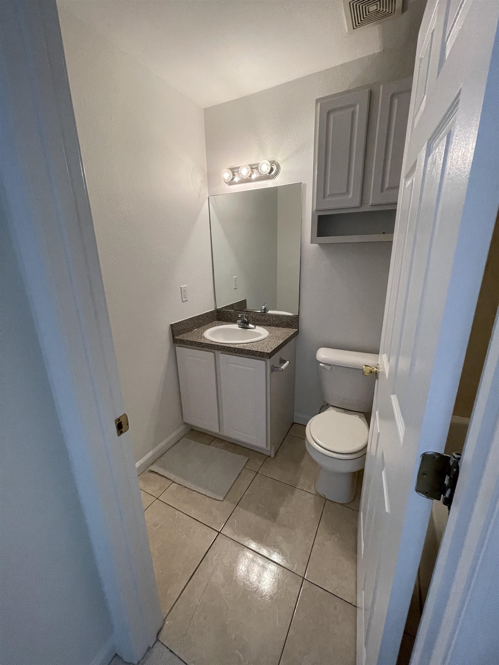4420 Carter Road, Unit 29 St. Augustine, FL 32086 - Photo 4 of 15 a bathroom with a toilet a sink and a mirror