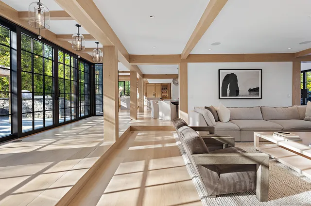 a living room with furniture and a floor to ceiling window