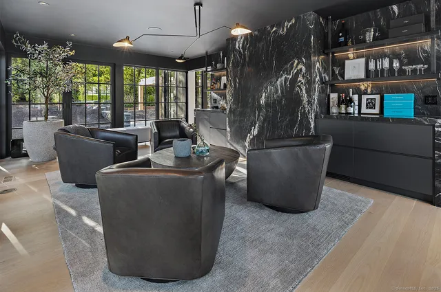 a living room with lots of furniture and a chandelier