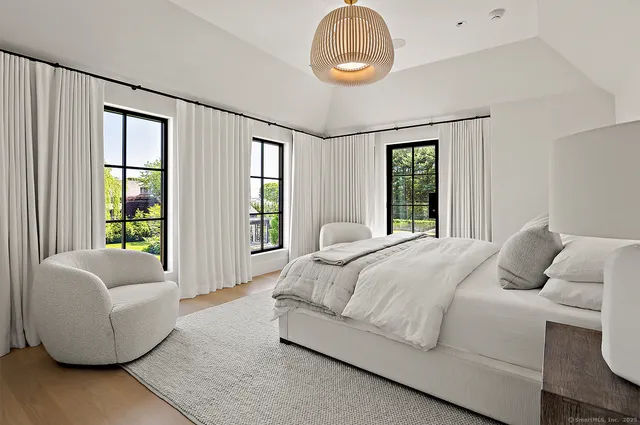 a bedroom with a large bed and a large window