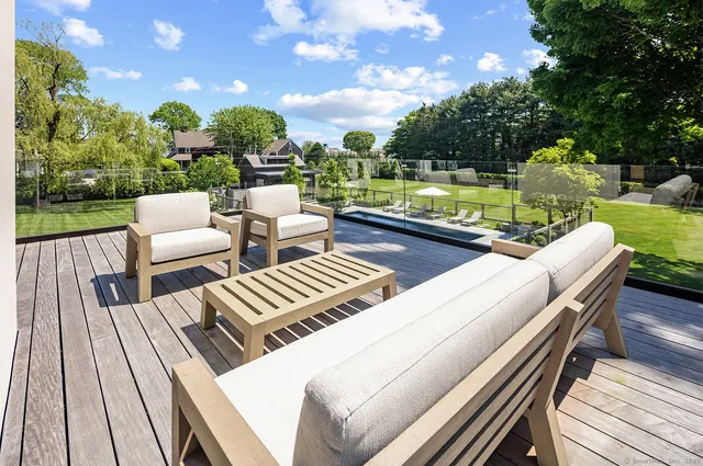 a view of a patio with lawn chairs next to a yard