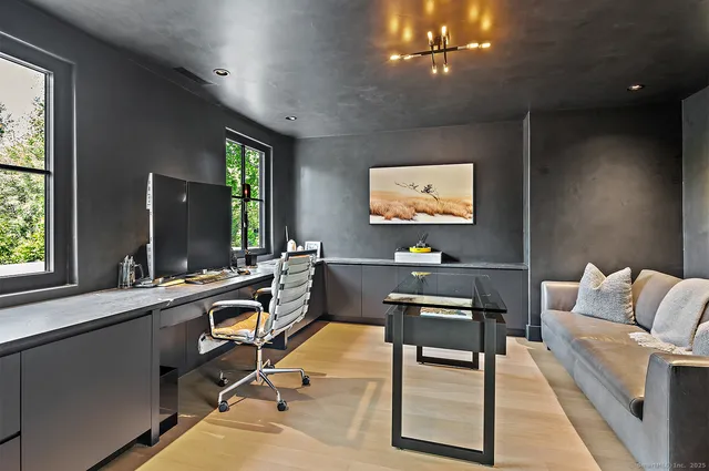 a living room with furniture a large window and a flat screen tv