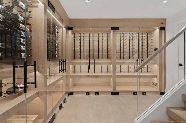 a view of a white house with a large windows and stairs