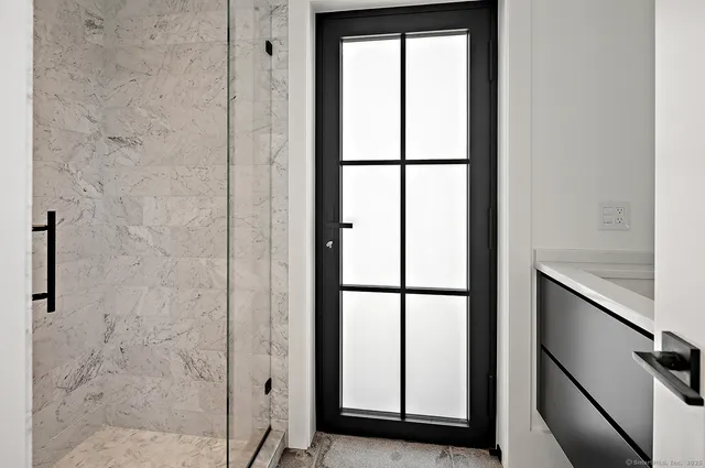 a bathroom with a glass shower door