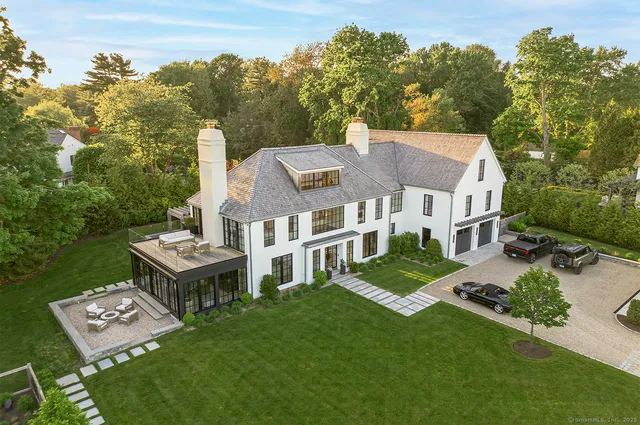 an aerial view of residential house with outdoor space and trees around