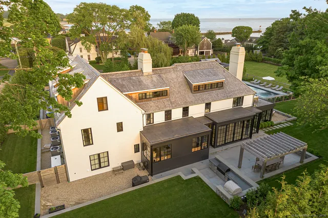 a view of a patio with a table and chairs under an umbrella