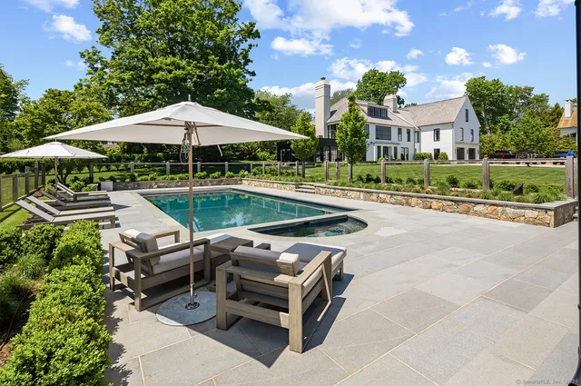 an aerial view of a house with a garden and lake view