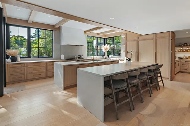 a kitchen with a stove a sink a dining table and chairs