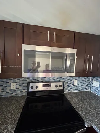 a stove top oven sitting inside of a kitchen
