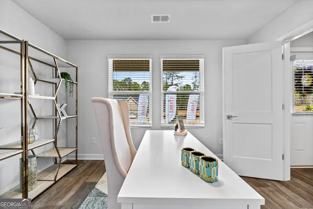 a bathroom with a granite countertop toilet sink and mirror