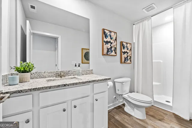 a kitchen with stainless steel appliances granite countertop a sink a stove a microwave a dining table and chairs