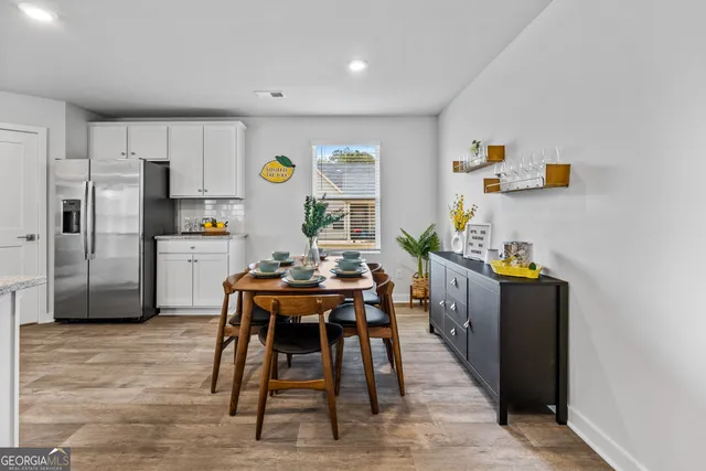 a view of a dining room with furniture and wooden floor