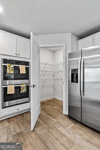 a kitchen with white cabinets and a sink