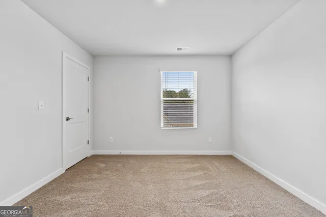 a bedroom with bed and window