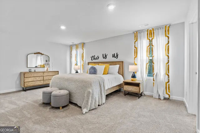 a spacious bedroom with a bed and a couch