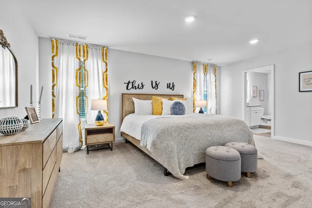 a bedroom with a bed and a view of bathroom