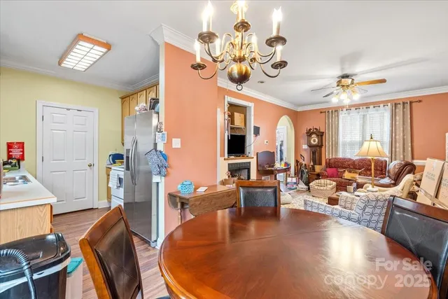a living room with fireplace furniture and a chandelier