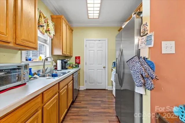 a kitchen with stainless steel appliances granite countertop a refrigerator and a stove