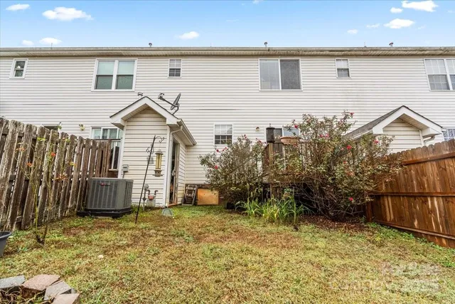 a backyard of a house with table and chairs
