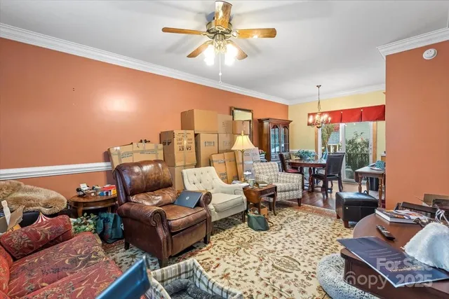 a living room with furniture ceiling fan and a rug