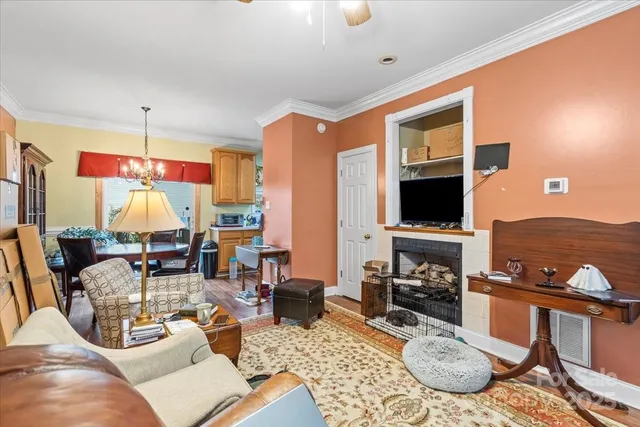 a living room with fireplace furniture and a flat screen tv