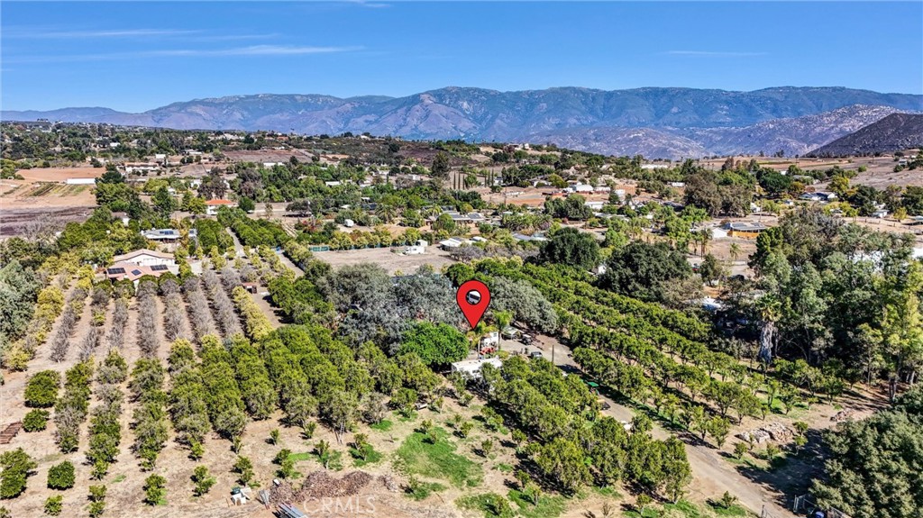 a view of a lush green hillside and houses
