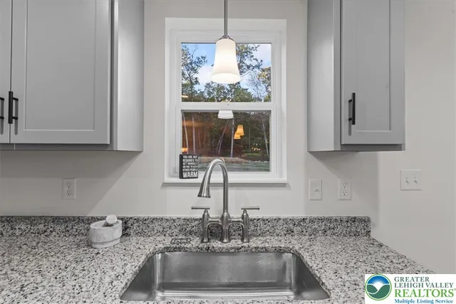 a kitchen with granite countertop a sink and a stove