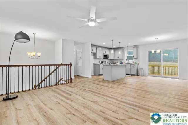 a view of a kitchen with a sink and dishwasher with wooden floor