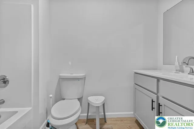 a white toilet sitting next to a bathroom sink