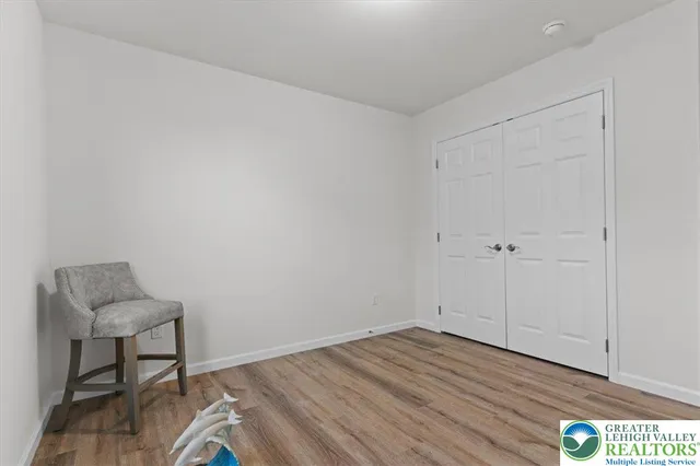 a view of a room with wooden floor and cabinet