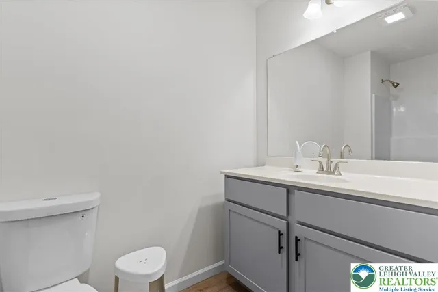 a bathroom with a sink a toilet and a mirror