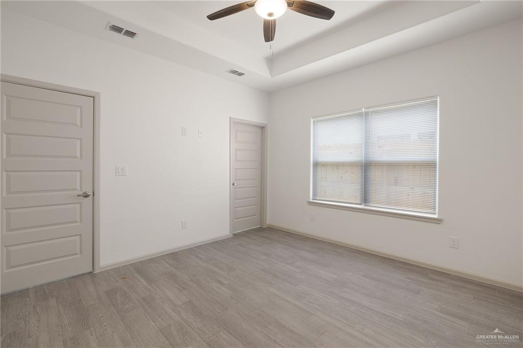 740 North Alamo Road, Unit 13 Alamo, TX 78516 - Photo 16 of 22 an empty room with ceiling fan and window