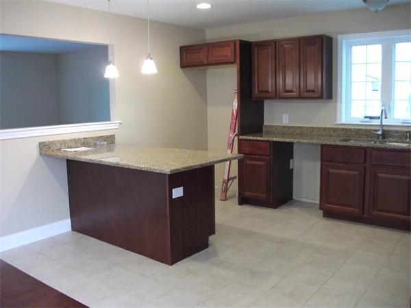 717 Warren Street Fall River, MA 02721 - Photo 5 of 10 a kitchen with stainless steel appliances granite countertop a refrigerator and a sink