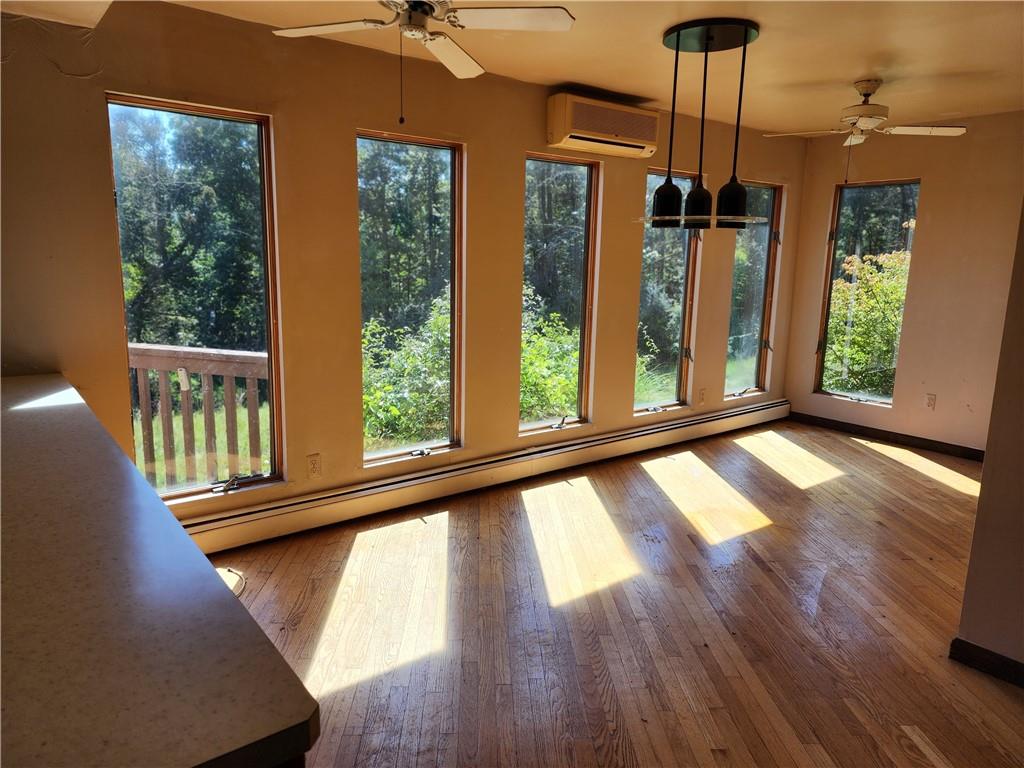 a view of an entryway with wooden floor and door