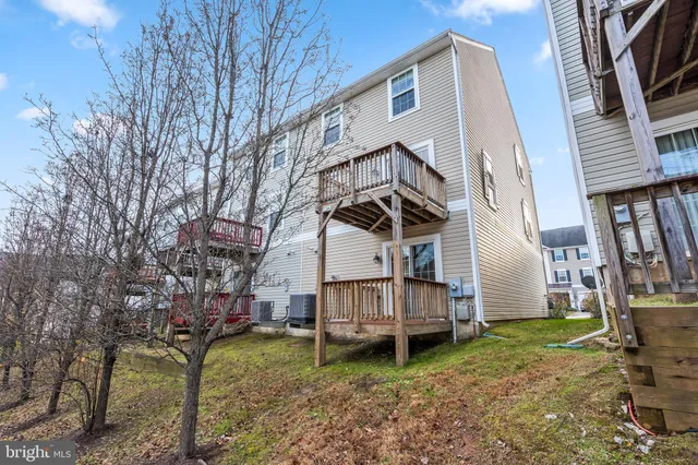 a backyard of a house with wooden fence and deck