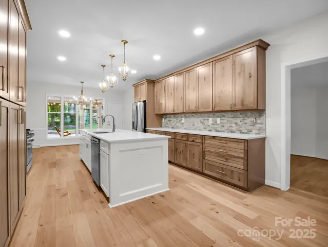 a kitchen with stove cabinets and wooden floor