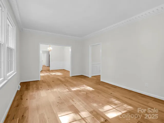 a view of an empty room with window and fire place